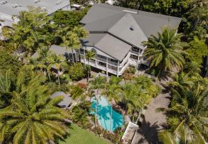 an aerial view of a house with a pool and palm trees at Garrick House in Port Douglas