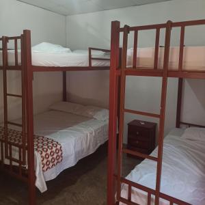 La Casa de Thurys في Pedasí Town: سريرين بطابقين في غرفة صغيرة مع سرير
