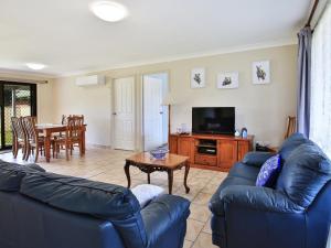 a living room with two blue couches and a television at Bahia I Pet Friendly I 10 Min Walk to Bay in Callala Bay