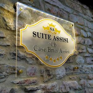 アッシジにあるSuite Assisiの石垣の看板