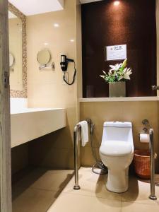 a bathroom with a toilet and a sink at Prime Asia Hotel in Angeles