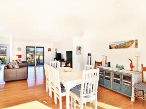 a dining room and living room with a table and chairs at The Palings at Culburra I Pet Friendly Masterpiece in Culburra Beach