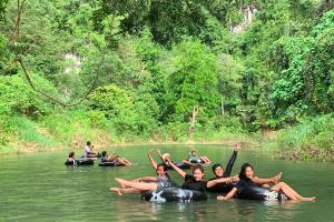 a group of people laying on rafts in the water at Khao Sok Riverside Cottages in Khao Sok National Park
