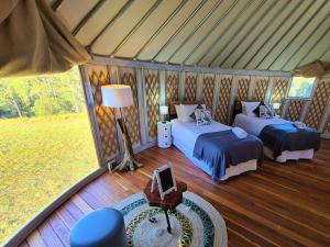 a bedroom with two beds in a tent at Noosa Eco Retreat in Pomona