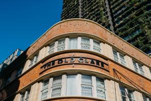 a brick building with a clock on the front of it at The Old Clare Hotel in Sydney