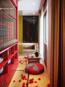 a room with a red pillow and flowers on the floor at Zen Hotel Hạ Long in Ha Long