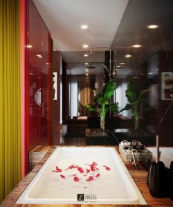a room with a table with flower petals on it at Zen Hotel Hạ Long in Ha Long