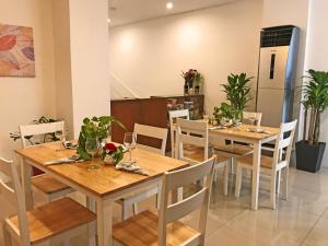 a dining room with wooden tables and white chairs at 538 Dormitel in Manila