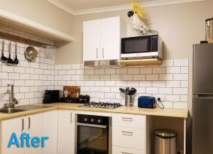 a kitchen with a stove and a microwave at Ferny Hill Retreat, Emerald Victoria in Emerald