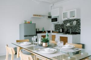 a dining room with a glass table and chairs at Like A Local in Chiang Mai