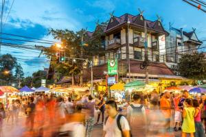a crowd of people walking in a busy street at night at 4 bedrooms Family at Chiang Mai Old City in Chiang Mai