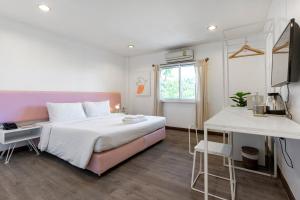 a bedroom with a large bed and a window at 4 bedrooms Family at Chiang Mai Old City in Chiang Mai