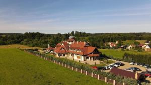 an aerial view of a large house in a field at Zajazd Bieszczadzka Ostoja in Ustrzyki Dolne