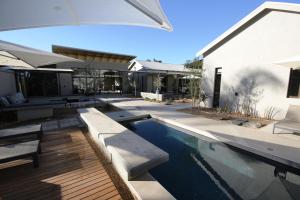 a swimming pool in the backyard of a house at The Elegant Guesthouse in Windhoek
