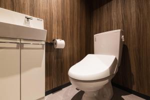 a bathroom with a white toilet and a sink at ENISIA BASE Kagonma in Kagoshima