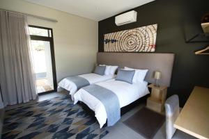 Ένα ή περισσότερα κρεβάτια σε δωμάτιο στο The Elegant Guesthouse
