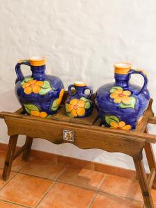 three vases sitting on top of a wooden table at El Antiguo Molino in El Bosque