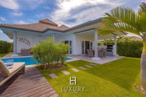 a villa with a garden and a swimming pool at Modern 3 Bedroom Pool Villa MP67 in Hua Hin
