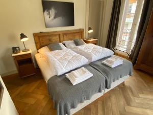 a bedroom with a bed with two towels on it at Hotel Hoheneck- self check-in in Engelberg