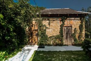 a brick building with a door in a yard at Mała Kuźnia in Lanckorona +4 photos