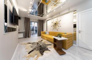 a living room with a yellow couch and a zebra rug at Pechersky Kvartal Apartments in Kyiv