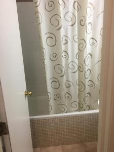y baño con bañera con cortina de ducha. en Estudio Los Cristianos, en El Guincho