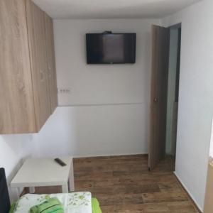 a living room with a tv on the wall at Petkovic Apartmani 3 in Tivat