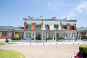 a large red and white building with a courtyard at Hotel Lasa Sport in Valladolid