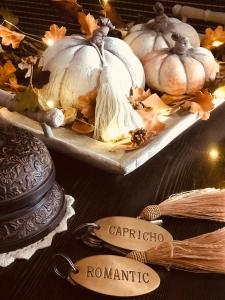 a group of pumpkins on a table with signs at Hostal Boutique Plaza Cantarero in Nerja