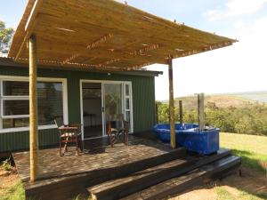 a deck with a hot tub and a wooden pergola at Mysthill Eco Cottage in Molen Drift