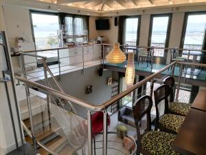 a room with a staircase with chairs and windows at Amfitriti Palazzo in Nafplio
