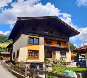 a house with a black and orange at Pension zu Hause in Uttendorf