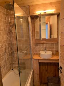 a bathroom with a glass shower and a sink at Mottaret in Méribel