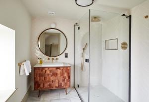 a bathroom with a sink and a mirror at The Ingham Swan in Stalham