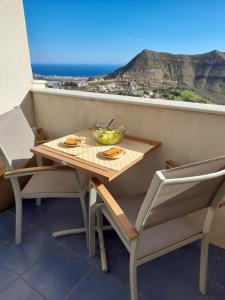 a table and chairs on a balcony with a view at Taina La Envia Golf in La Envia