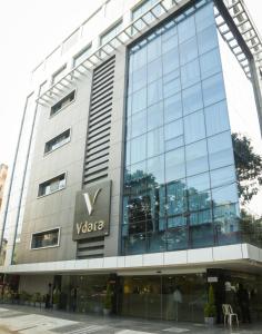 a tall building with a viva sign on it at Hotel Vdara in Vijayawāda