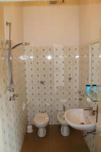 a bathroom with a sink and a toilet and a shower at Hotel Residence Ponente in Cesenatico