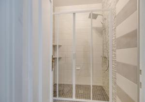 a shower with a glass door in a bathroom at Fauriel Aimé in Saint-Étienne