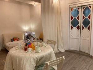 a table with cups and saucers on it in a room at MY HOME SCARPERIA in Scarperia