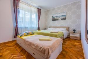 Posteľ alebo postele v izbe v ubytovaní Apartment LEO NONA