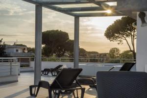 a patio area with chairs, a table and a balcony at Acca residence in Terracina