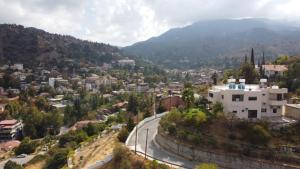 an aerial view of a city with a winding road at Kakopetria Heights in Kakopetria