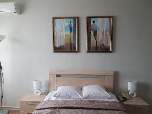 a bedroom with two pictures on the wall and a bed at Hotel Aviastar in Ulyanovsk