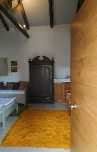 a room with a door and a room with a bed at manesi stone built studio in Manésion