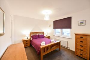 a bedroom with a bed and a window at Harbour Quay Apartment in Irvine