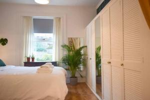 a white bedroom with a bed and a window at Mount Pleasant Brixham in Brixham