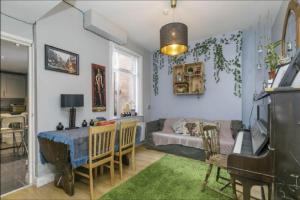 a living room with a table and a couch at Big Yellow Door in Queens Quarter in Belfast