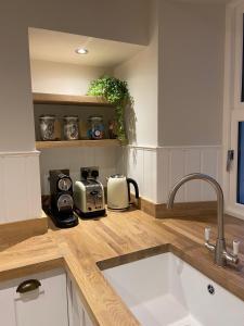 a kitchen with a sink and a counter top at Bailey Cottage in Gargrave