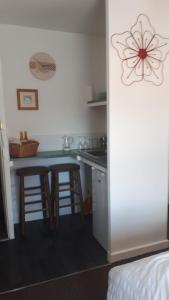 a kitchen with a counter and two bar stools at Readers Retreat in Wigtown