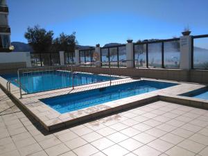 a swimming pool on top of a building at Hotel Marian Platja in Roses